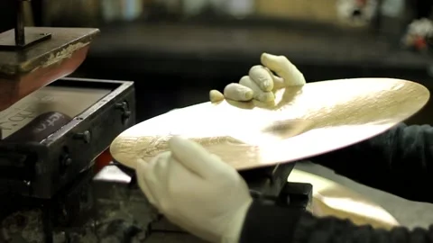 Worker stamping new cymbals with machine Video stock 237620733
