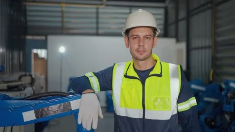 Worker stands beside industrial robot arm Video stock 341316115