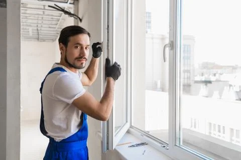 The worker stands at the open window Stock Photos
