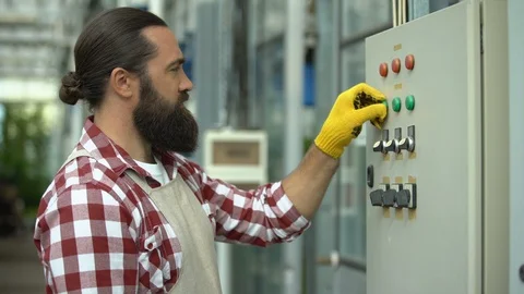 Worker starting climate control and irrigation system, greenhouse technologies Stock Footage 118920629