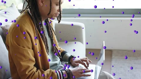 Worker starting typing on laptop, leaning, camera revealing face, purple dots Video stock 333234020