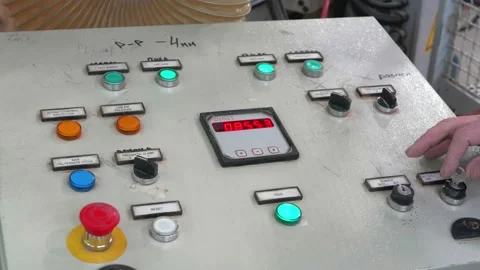 Worker starts the machine in production, including the control buttons Stock Footage 231977613