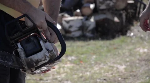 Worker starts a petrol chainsaw Stock Footage 59937888
