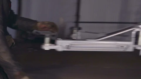 A worker at the station checks the condition of the car lift Stock Footage 104151060