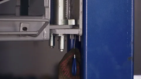 Worker at the station checks the condition of the car lift close-up Stock Footage 104151103