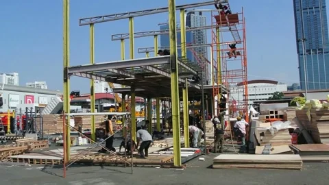 The worker is still working as a booth contractor at a trade expo exhibition 스톡 동영상 285110372