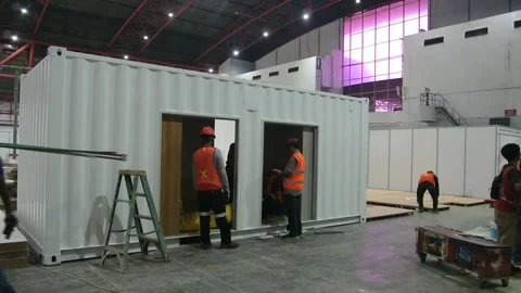 The worker is still working as a booth contractor at mining expo exhibition Stock Footage 290851992
