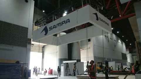  the worker is still working as a booth contractor at mining expo exhibition Stock Footage 290880390