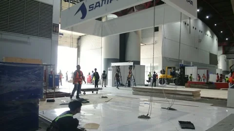  the worker is still working as a booth contractor at mining expo exhibition 스톡 동영상 290880397