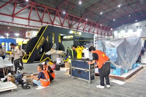 The worker is still working as a booth contractor at mining expo exhibition Stock Photos