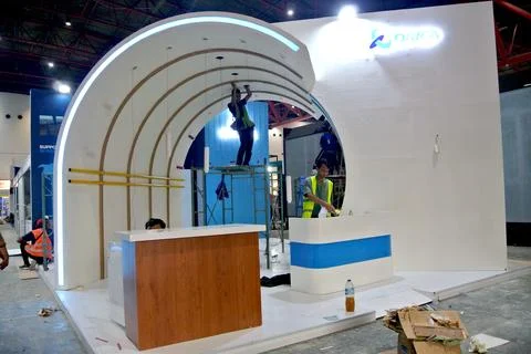 The worker is still working as a booth contractor at mining expo exhibition Stock Photos