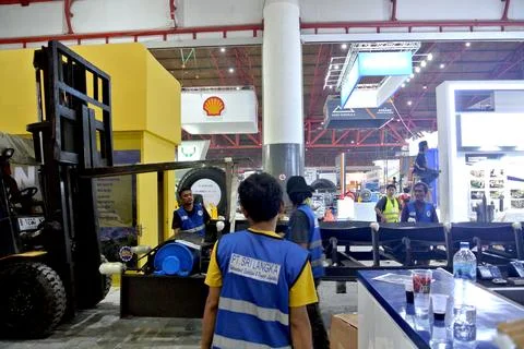 The worker is still working as a booth contractor at mining expo exhibition Photos
