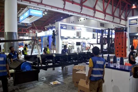 The worker is still working as a booth contractor at mining expo exhibition Photos