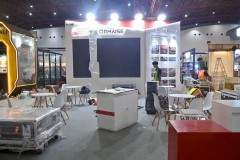 The worker is still working as a booth contractor at mining expo exhibition Stock Photos