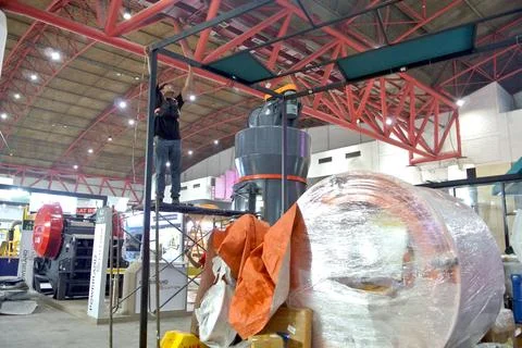The worker is still working as a booth contractor at mining expo exhibition Stock Photos