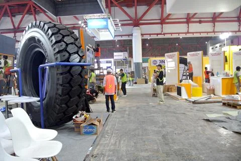The worker is still working as a booth contractor at mining expo exhibition Stock Photos