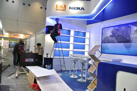 The worker is still working as a booth contractor at mining expo exhibition Stock Photos