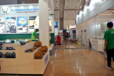 The worker is still working as a booth contractor at mining expo exhibition Stock Photos