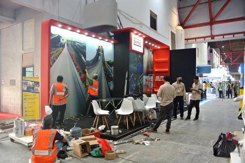 The worker is still working as a booth contractor at mining expo exhibition Photos