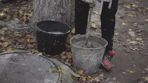 Worker stirs cement with a hand mixer Stock Footage 260642068
