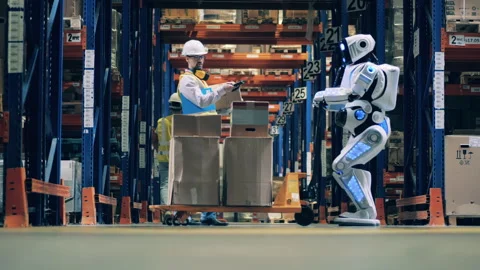 Worker stops robot to place an extra box to his cart at modern warehouse Video stock 142590342