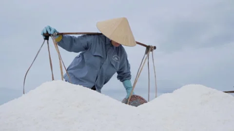 Worker Struggles to Dump Salt Stock Footage 42446584