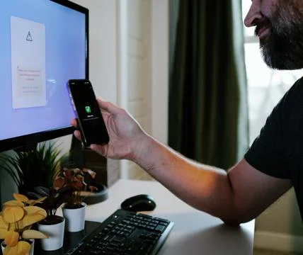 Worker Struggles with Two Factor Authentication Stock Photos