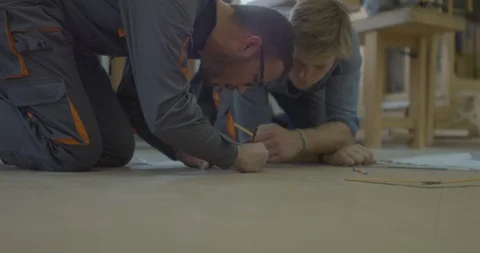 Worker students drawing plans on the floor - Close - 4K Stock Footage 97749803
