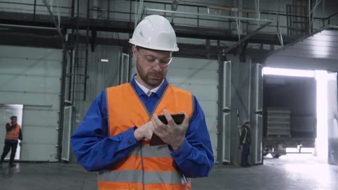 Worker supervises the shipment supply loading at an industrial factory warehouse Stock Footage 278184488