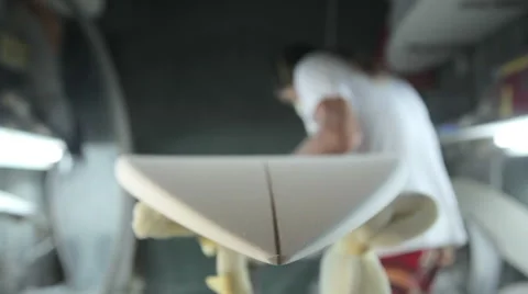 A worker in a surfboard shaping room Stock Footage 64410415