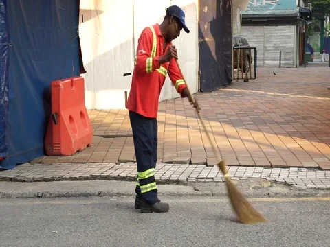Worker sweeping on the road Stock Footage 107173194