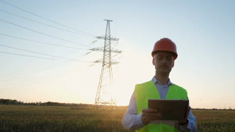 Worker with a tablet on the background of an electro pillar. Video stock 137457976
