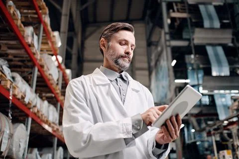 Worker with tablet at the factory Stock Photos