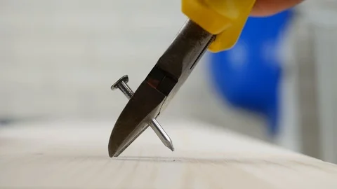 Worker Take Out a Nail Using a Pliers for Removing Nails Stock Footage 122257802