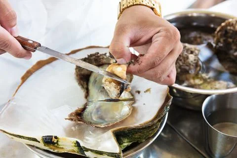 Worker take the pearl from shell Stock Photos