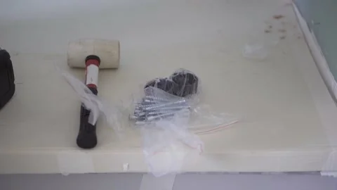 The worker takes the fittings from the table for assembling furniture. Stock Footage 157288552