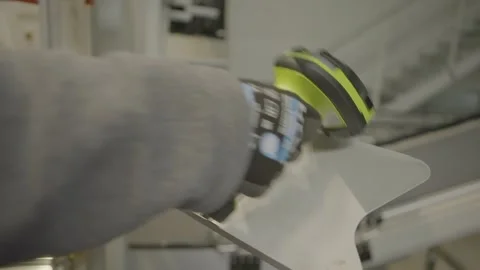 A worker taking a bar code scanner and putting it back Stock Footage 280748802