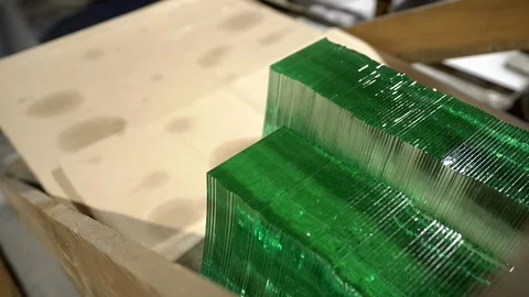 A worker taking green glass elements from a stack.Taking glass elements Stock Footage 124155854