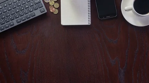 Worker taking notes to the notebook on wooden desk Stock Footage 75943438
