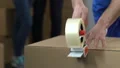Worker taking out boxes, young family crying background, financial difficulties HD Footage