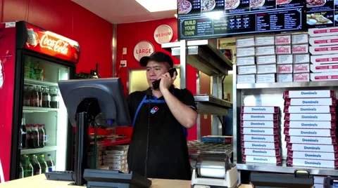 Worker taking phone call for customer ordering Domino pizza Stock-Footage 65127545