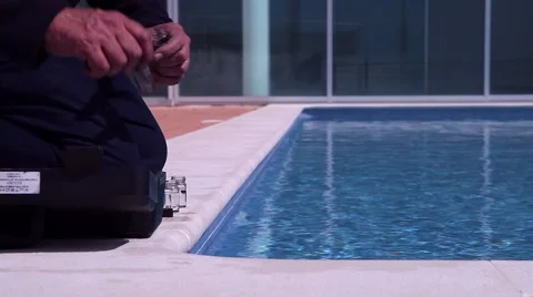 Worker taking water samples from pool for quality control Stock Footage 62356263