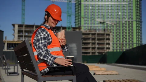 Worker is taking a well deserved break on site, enjoying a cup of coffee Stock Footage 311860442