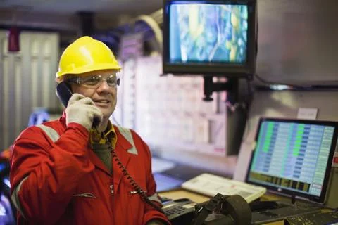 Worker talking on phone in control room Stock Photos