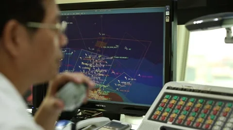 A worker is talking on radio transceiver in the vessel traffic service center. Stock Footage 66456086