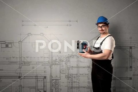 Worker with technical drawing. Stock Photos