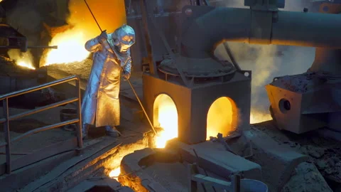 Worker with termic suit in factory - molten cast iron Stock Footage 249621033