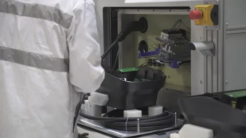 Worker testing product on assembly line. Conveyor work Stock Footage 211818166