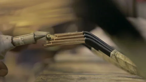 Worker tests electrical current in armature Stock Footage