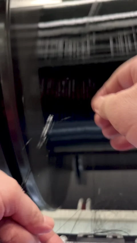 A worker in the textile industry repairs a damaged monofilament winding Stock Footage 289607457